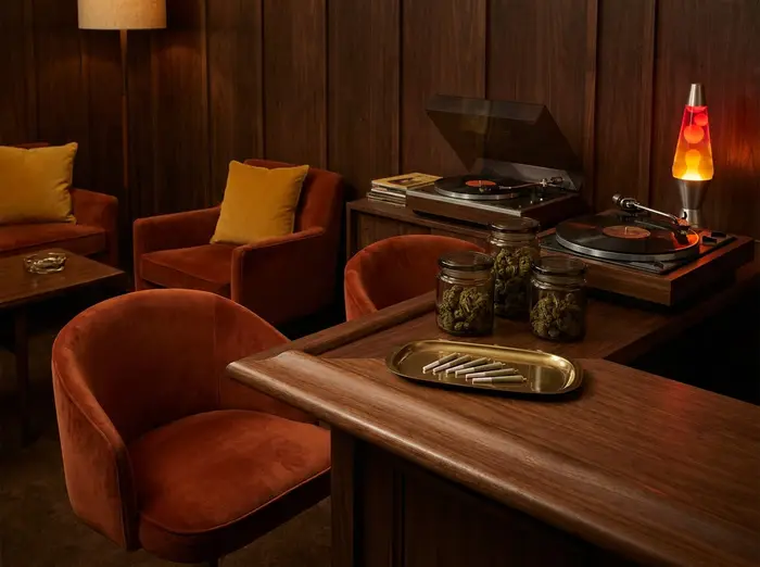 A warm listening lounge with velvet chairs, a record player, and a prepared service tray